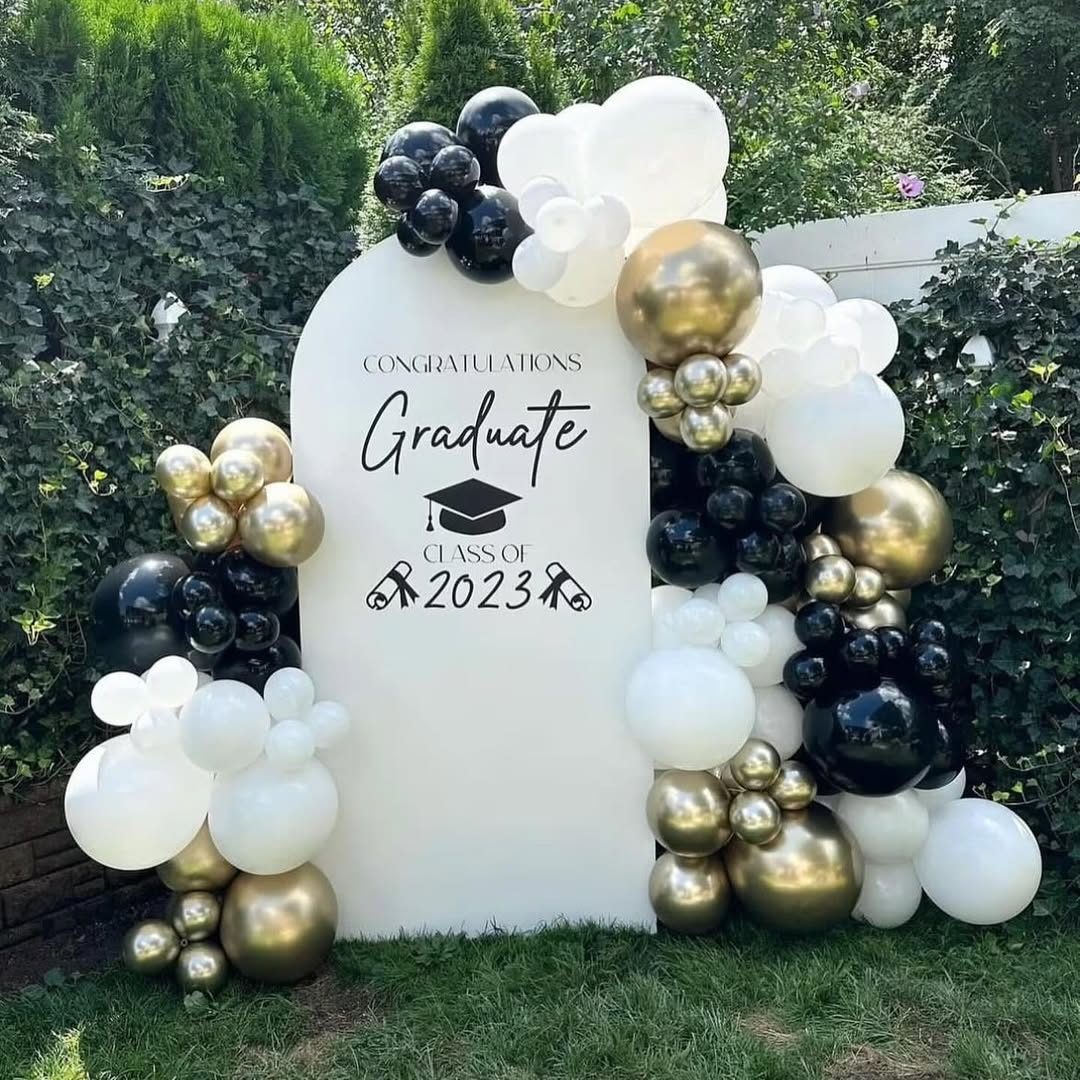 Graduation party setup with school-colour balloon arch, cake table and seating in Nairobi