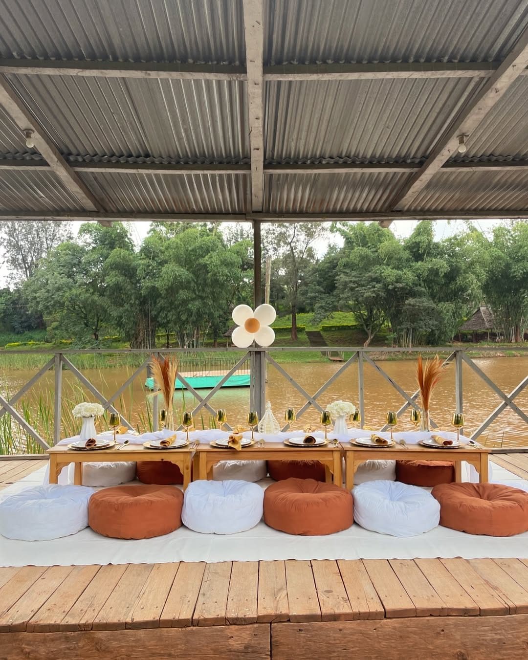 Luxury boho adult picnic setup with floor cushions, low table and balloon backdrop in Nairobi